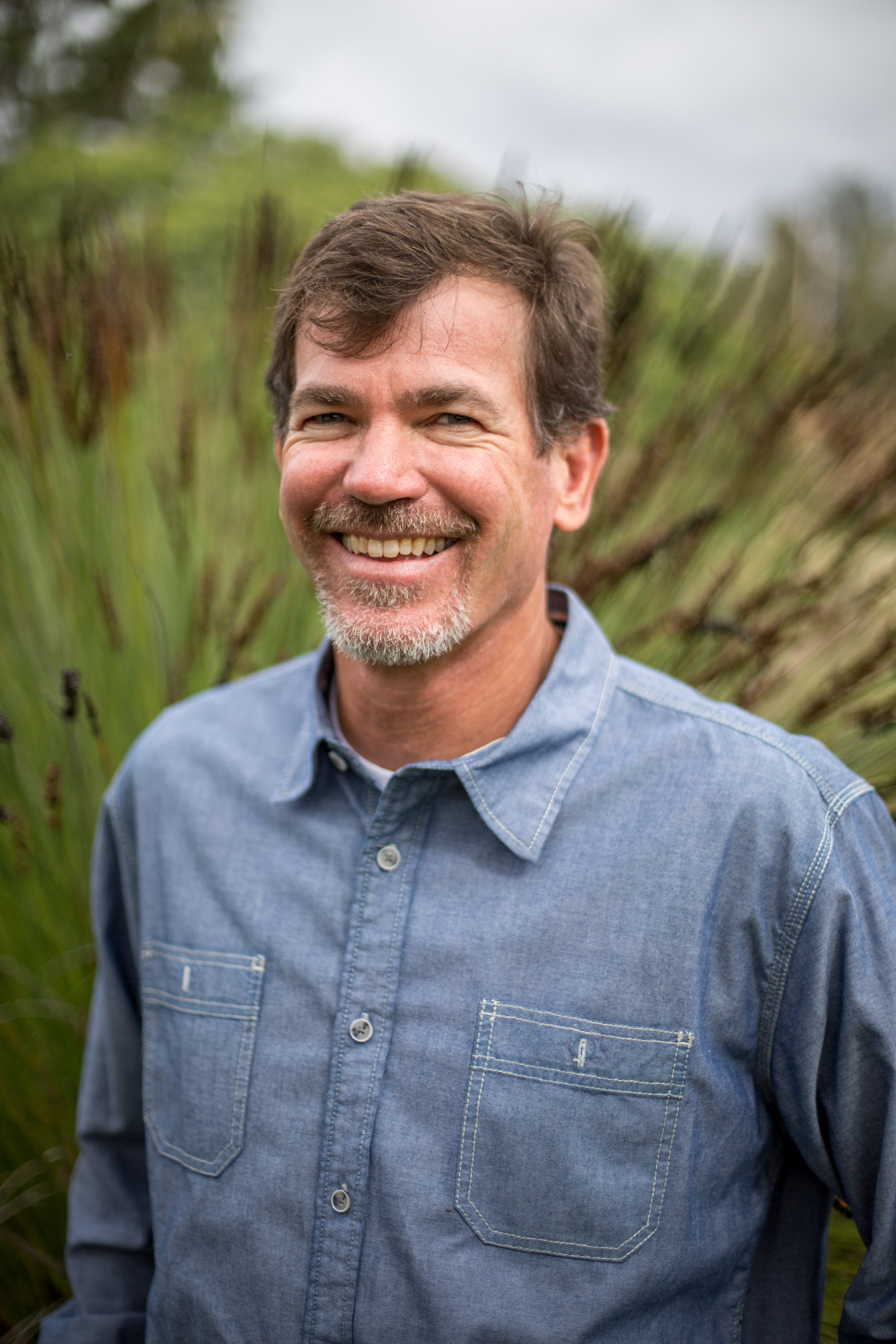 Jay Ruskey wearing jean collar shirt on the farm.